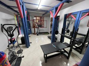 a room with a gym with a treadmill at Cabaña con vista al Río in Ibagué