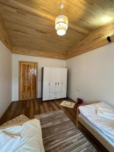 a bedroom with two beds and a wooden ceiling at Villa Nar in Cıralı