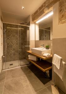 a bathroom with a sink and a shower at Goloritzè Room and Breakfast in Baunei