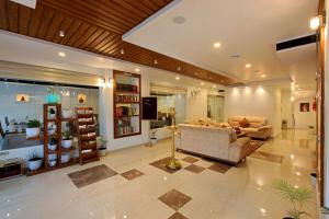 a large living room with a couch and a tv at Hotel NovArk Munnar in Kallar Vattiyar