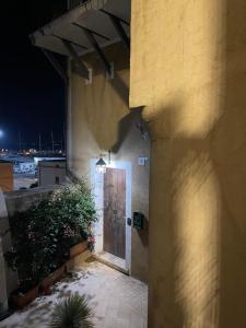 a door on the side of a building at night at La Finestra Sul Porto in Termoli