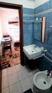 a bathroom with a sink and a toilet and a table at janas in Tortolì