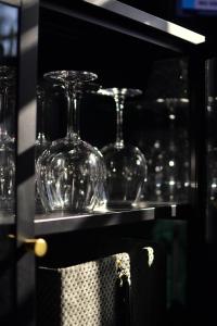 a shelf with wine glasses on top of it at One-bedroom apartment in the center of Saariselkä in Saariselka