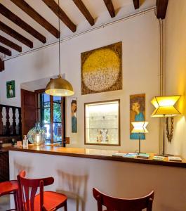 a bar in a room with chairs and lights at Ca'n Abril in Sóller