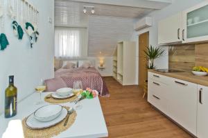 eine Küche und ein Wohnzimmer mit einem Bett und einem Tisch in der Unterkunft *Beautiful, centrally located studio apartment* in Hvar