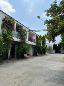 a building with two benches in front of it at BK Hotel in Phnom Penh