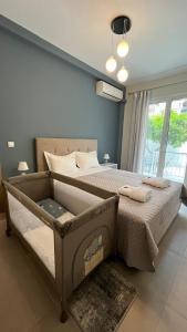 a bedroom with a large bed and a window at Comfy Apartment in Nafplio