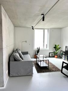 a living room with a couch and a table at Weinberg-Design-Apartment Stuttgart-Fellbach in Fellbach