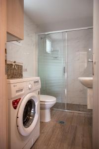 uma máquina de lavar roupa na casa de banho com WC em Konstantina's Luxury Apartment em Nafplio