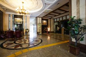 a lobby of a hotel with a plant in the middle at Aura Hotel in Ansan