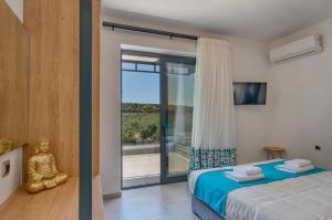 a bedroom with a bed and a large window at Luxurious villa Micha Mare - 14 Bedrooms in Roumelí +45 photos
