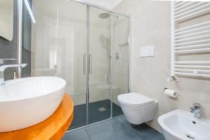 a bathroom with a tub and a sink and a toilet at Ville Palà Luxury - Castro by HDSalento in Castro di Lecce