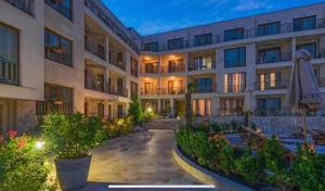 an exterior view of a hotel at night at Diamond Beach Sea View Studios in Burgas