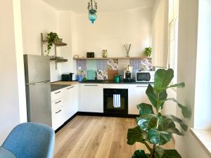 a kitchen with white cabinets and a refrigerator at Taormina Casa Sarina in Taormina