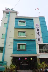 a blue and white building with a sign on it at CHETAN INN HOTEL in Bhubaneshwar