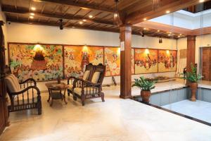 a living room with a large painting on the wall at Vajra Ayurveda and Yoga Retreat in Cochin