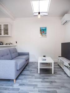 a living room with a couch and a table at Logement Le Serein in Toulon