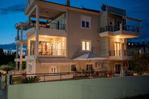 a large house with an umbrella in front of it at Konstantina's Luxury Apartment in Nafplio
