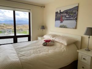 a bedroom with a bed and a large window at Apartment at Island Cottage, Inishnee, Roundstone in Galway