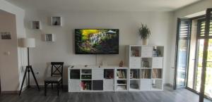a living room with a tv on a wall at Beautiful seaside 2 bedroom apartment Babina in Rabac