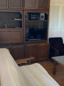 a room with a cabinet with a bed and a table at Apartment Raslina in Raslina