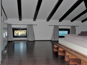 a living room with two beds and a television at Beautiful seaside 2 bedroom apartment Babina in Rabac