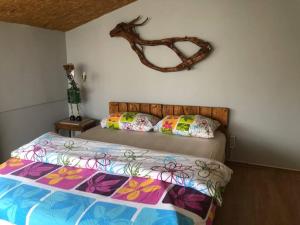 a bedroom with a bed with a deer head on the wall at TARİHİ KALEİÇİ MUHTEŞEM DİZAYN HUZURLU KEYİFLİ TERAS KEYİFLİ ÖZEL ev in Antalya