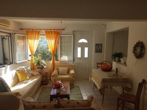 a living room with a couch and a table at Under the Red Rock and View Studio in Áyioi Apóstoloi