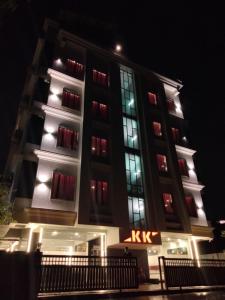 a tall building with a kx sign in front of it at HOTEL AIRPORT KK in Nagpur