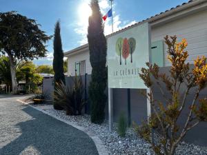 a building with a sign that reads in c garden at Camping La Chênaie in Les Mathes