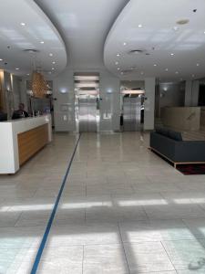 a lobby with a reception desk in a building at Embassy 812 free parking in Adelaide