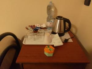 a table with a tea kettle and glasses on it at Piccola Perla Guest House in Valmontone