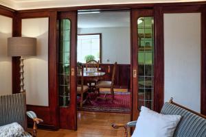 a living room with glass doors and a table at Ferienwohnung Weiß in Hilchenbach