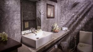 a bathroom with a sink and a toilet at Baan Manali Resort in Thongsala +37 photos