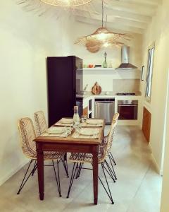 a dining room with a wooden table and chairs at La Maison Boheme by Fra Cielo e Mare in Cagliari