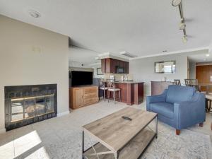 a living room with a blue couch and a fireplace at 223 Edgewater Inn in Charlevoix