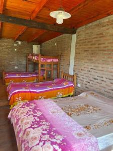 Habitación con 4 camas y techo. en Rincón del Potro en Paso de la Patria