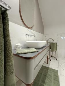 a bathroom with a sink and a mirror at Maison et Florescence in Nuits-Saint-Georges