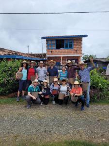 a group of people posing for a picture in front of a house at Chalet Ecoturismo La Nohelia in Jericó