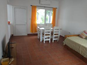 Zimmer mit einem Tisch, Stühlen und einem Fenster in der Unterkunft Coneta, casa de Dios in San Fernando del Valle de Catamarca