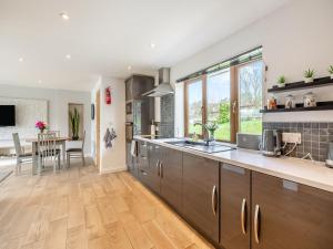 a kitchen with a large counter and a dining room at Honey Bee - Uk43395 in Chardstock