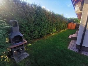 a backyard with a wood stove in the grass at Dom parterowy 80m2 - 300 METRÓW OD MORZA in Sianozety