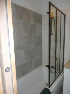a shower with a glass door in a bathroom at Houlgate in Houlgate
