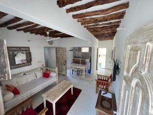 a living room with a couch and a table at Beytsalaam Apartments in Lamu