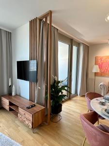 a living room with a flat screen tv on a wall at The View 15.06 Quartier Belvedere in Vienna