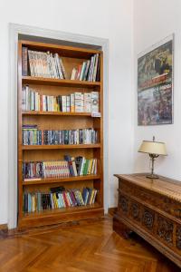 a room with a book shelf filled with books at Italy Prestigious Guest House in Bologna