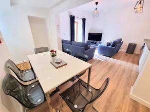 a living room with a table and chairs at South Terrace Apartment by Cliftonvalley Apartments in Weston-super-Mare