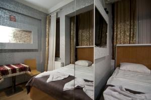 a small bedroom with two beds and a mirror at The New Season Apart in Istanbul