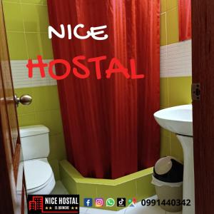 a bathroom with a red shower curtain and a toilet at Nice Hostal El Quinche in Quinche