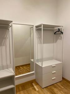 a closet with white cabinets and a glass door at Dimora Centro Storico Roma in Rome